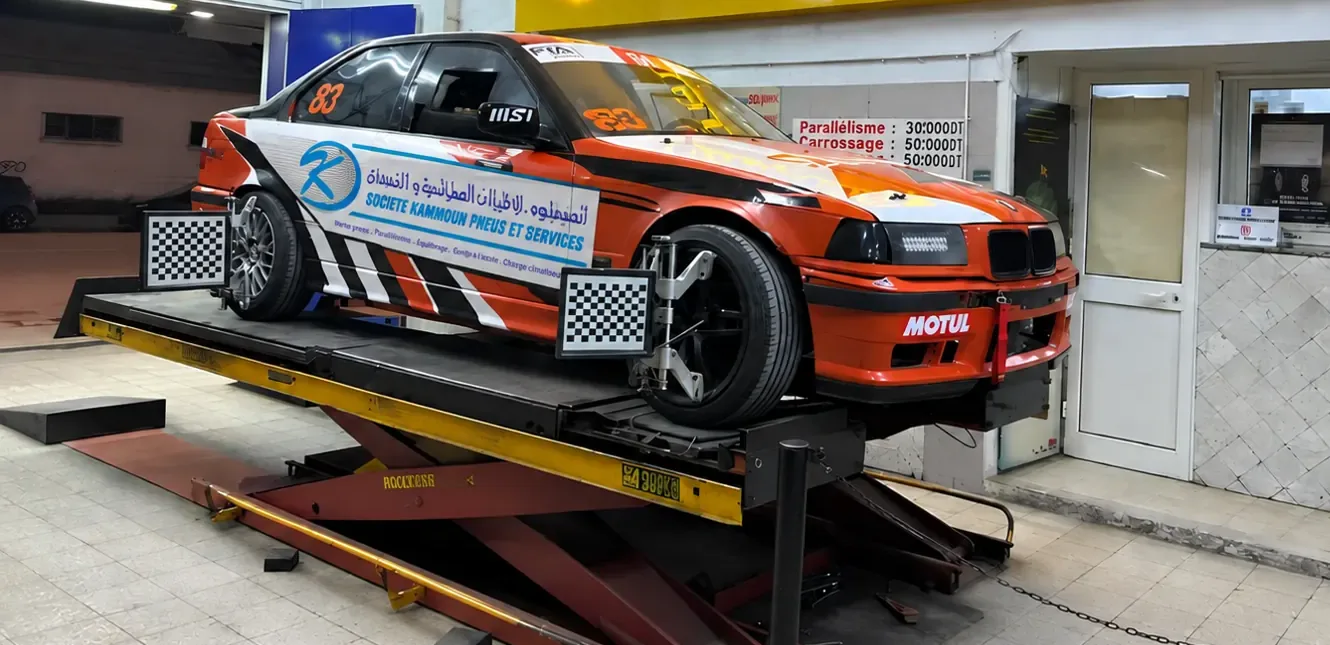 The S.K.P.S-sponsored BMW race car on the 3D alignment lift